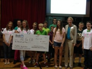Students from Anna Tangen's homeroom present St. Michael's Elli Hoffmeister with a check for $1,000. (Photo submitted)
