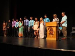 Recipients of the inaugural Luke Letellier Memorial Scholarship join Luke's parents, Jenny and Rob (at podium) on stage at Wednesday's Scholarship Awards Night at STMA High School. 