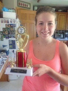 Elli Hofmeister poses with her third place trophy for the All for Elli Float in the AFCD Parade back in June. 