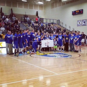 Members of the STMA Stallions basketball program receive a fundraising check from the STMA Knights boys' basketball program earlier this month. Together, the boys' and girls' basketball team have raised hundreds for the Stallions this season. 