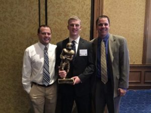 STMA state champion Elijah Rice poses with coaches Jared Essler (left) and Keith Cornell of the STMA football team after accepting his Minnesota Football Honor last week in Minneapolis. 
