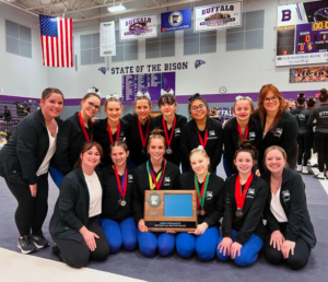 The Knights gymnastics team poses with the Section 5 Class AA title. They placed fifth at state.